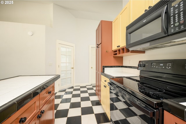 865 SE Roberts Ct, Mcminnville, OR 97128 - kitchen featuring tile countertops, dark floors, vaulted ceiling, and black appliances