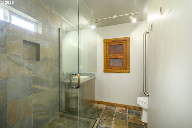 865 SE Roberts Ct, Mcminnville, OR 97128 - full bath with track lighting, toilet, stone finish floor, baseboards, and a stall shower