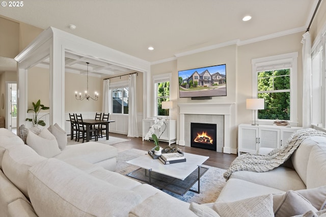 16943 SW Snowdale St, Beaverton, OR 97007 - living room with coffered ceiling, a chandelier, a glass covered fireplace, recessed lighting, and crown molding