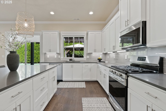 16943 SW Snowdale St, Beaverton, OR 97007 - kitchen featuring appliances with stainless steel finishes, a sink, ornamental molding, backsplash, and recessed lighting