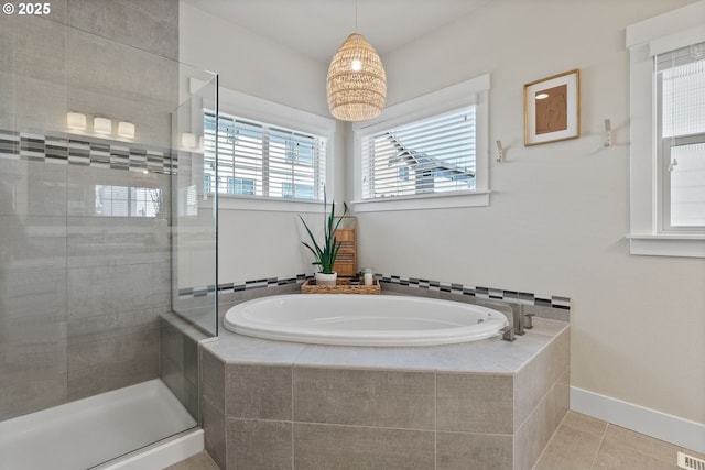 16943 SW Snowdale St, Beaverton, OR 97007 - bathroom with a garden tub, a stall shower, tile patterned floors, and baseboards