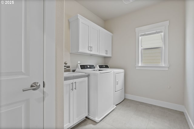 16943 SW Snowdale St, Beaverton, OR 97007 - laundry room with washer and clothes dryer, baseboards, and cabinet space