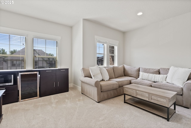 16943 SW Snowdale St, Beaverton, OR 97007 - living area with beverage cooler, healthy amount of natural light, light carpet, and recessed lighting