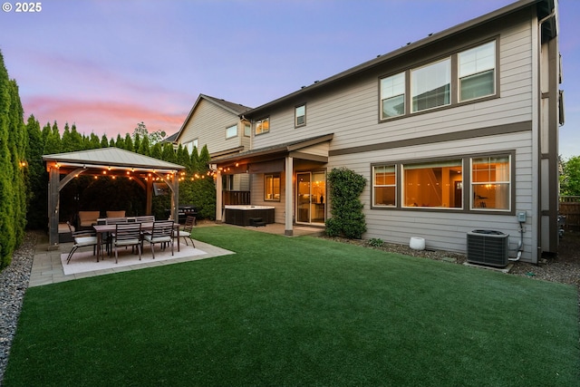 16943 SW Snowdale St, Beaverton, OR 97007 - back of property with a hot tub, a gazebo, a patio, a lawn, and central AC