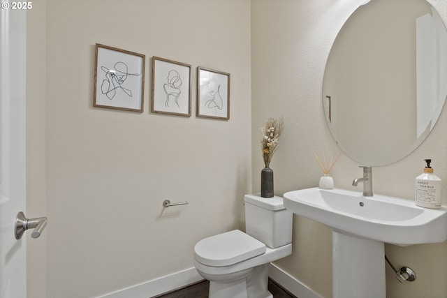 16943 SW Snowdale St, Beaverton, OR 97007 - bathroom with toilet, baseboards, wood finished floors, and a sink