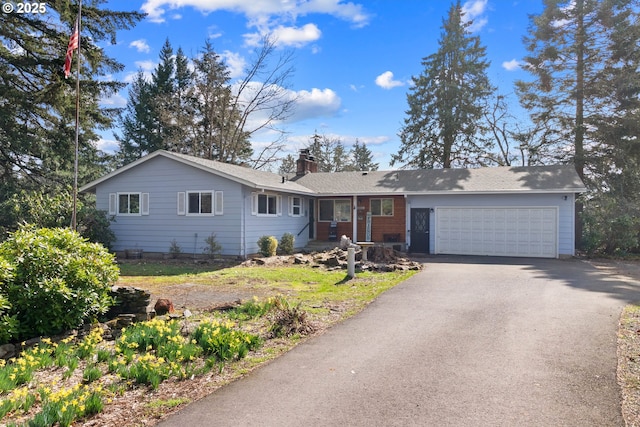 ranch-style home with aphalt driveway, a garage, and a chimney