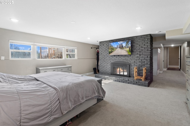 bedroom with recessed lighting, baseboards, light colored carpet, and a fireplace