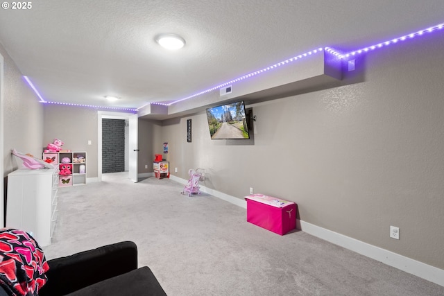 playroom with baseboards, visible vents, carpet floors, a textured ceiling, and a textured wall