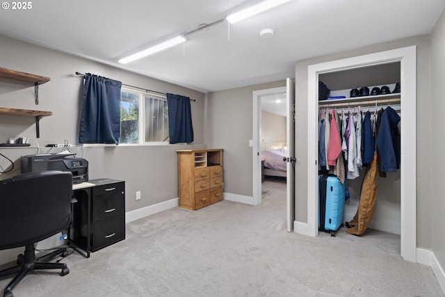 office space featuring light carpet and baseboards