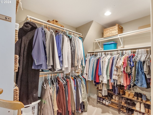 walk in closet with carpet