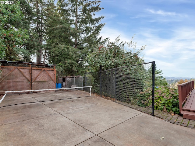 view of patio / terrace featuring tennis court