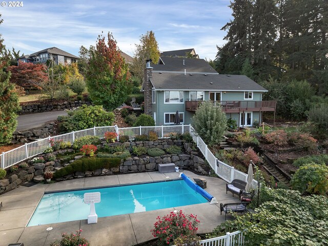 view of swimming pool featuring a diving board