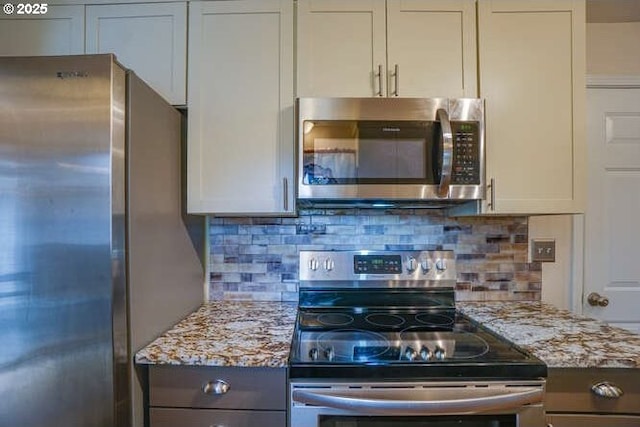 2919 SE 3rd Ave, Camas, WA 98607 - kitchen with stainless steel appliances, light stone countertops, and backsplash