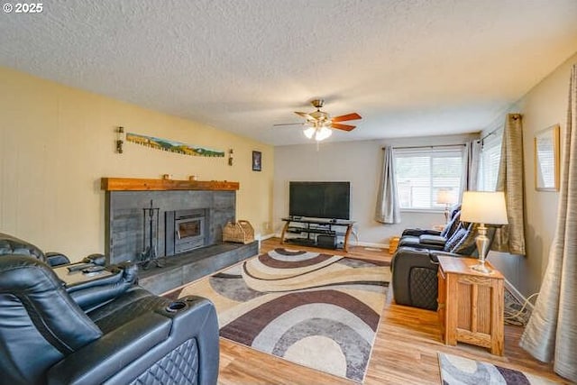 2919 SE 3rd Ave, Camas, WA 98607 - living room with a fireplace, a ceiling fan, wood finished floors, and a textured ceiling
