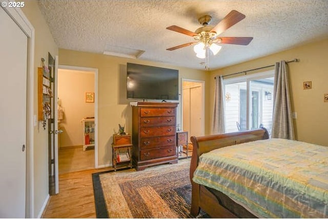 2919 SE 3rd Ave, Camas, WA 98607 - bedroom with a textured ceiling, wood finished floors, attic access, and ceiling fan