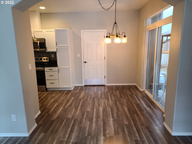 667 SE 5th Ave, Hillsboro, OR 97123 - unfurnished dining area featuring dark wood finished floors, arched walkways, recessed lighting, and a chandelier