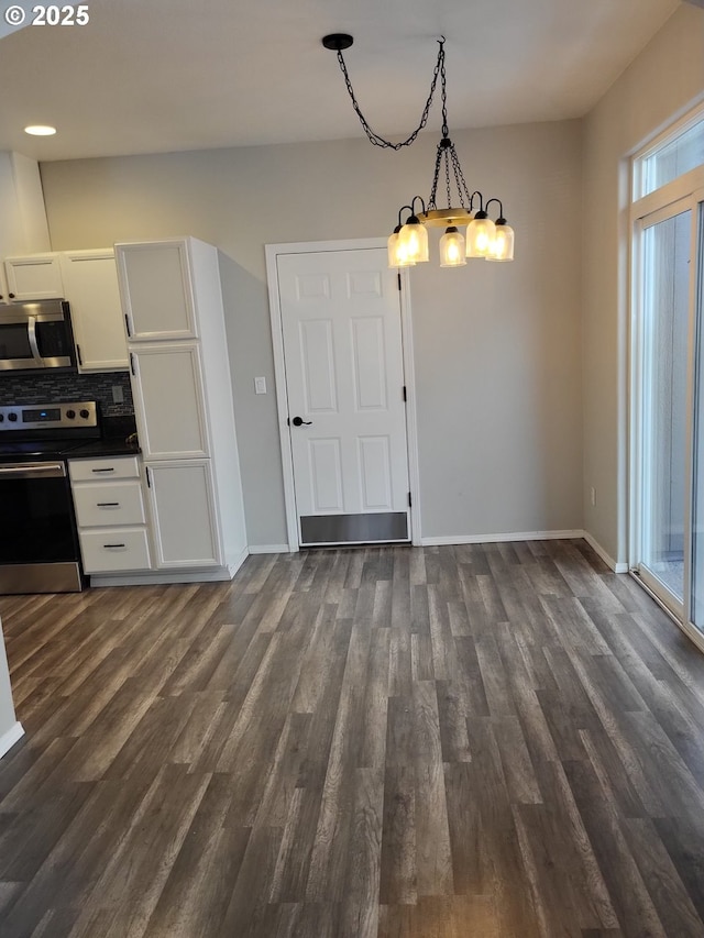 667 SE 5th Ave, Hillsboro, OR 97123 - kitchen featuring appliances with stainless steel finishes, a chandelier, dark wood-style flooring, and dark countertops