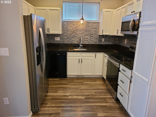 667 SE 5th Ave, Hillsboro, OR 97123 - kitchen with appliances with stainless steel finishes, white cabinets, dark wood-style flooring, decorative backsplash, and decorative light fixtures