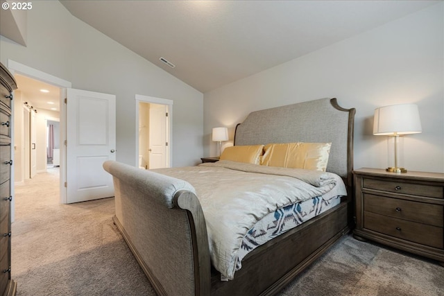 bedroom with vaulted ceiling, visible vents, and light colored carpet