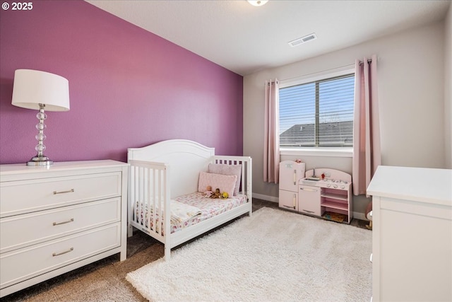 carpeted bedroom with baseboards and visible vents