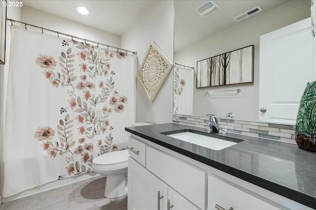 bathroom featuring tasteful backsplash, visible vents, toilet, tile patterned flooring, and vanity