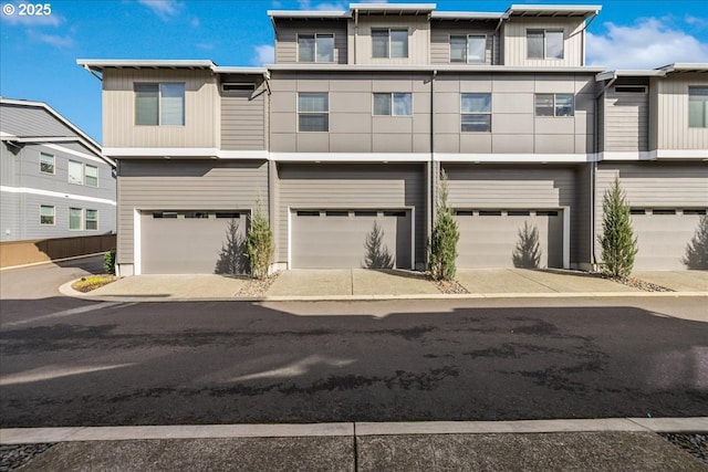 view of property featuring driveway and an attached garage