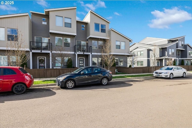 view of building exterior with a residential view and fence