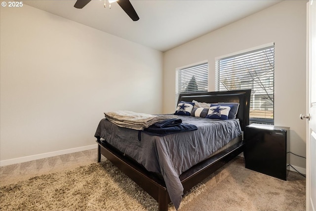 carpeted bedroom featuring ceiling fan and baseboards