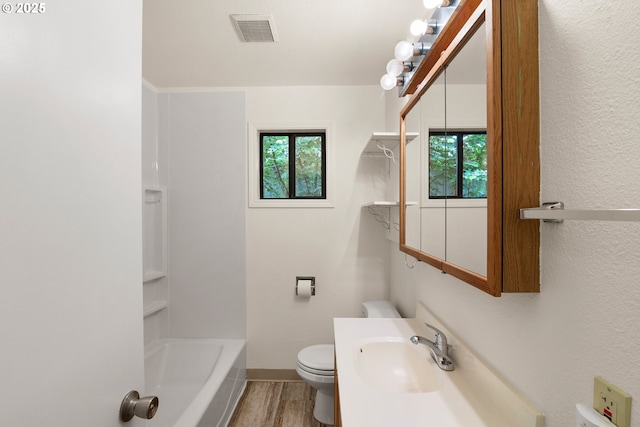 7940 SE 75th Pl, Portland, OR 97206 - full bath featuring healthy amount of natural light, toilet, wood finished floors, vanity, and a textured wall