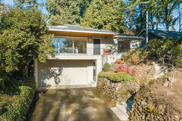 view of front of property with a garage and a balcony