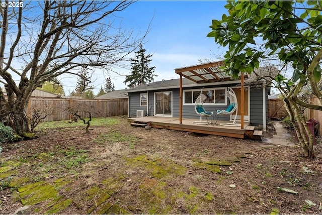 back of house featuring a fenced backyard and a wooden deck