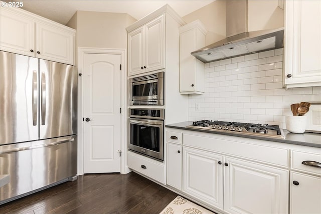 2025 De Vries Way W, Linn, OR 97068 - kitchen featuring stainless steel appliances, wall chimney range hood, backsplash, white cabinets, and dark wood-style flooring