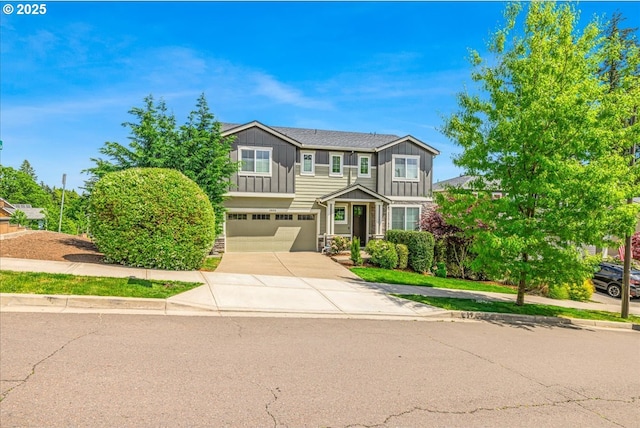 2025 De Vries Way W, Linn, OR 97068 - view of front of house featuring board and batten siding, stone siding, an attached garage, and driveway