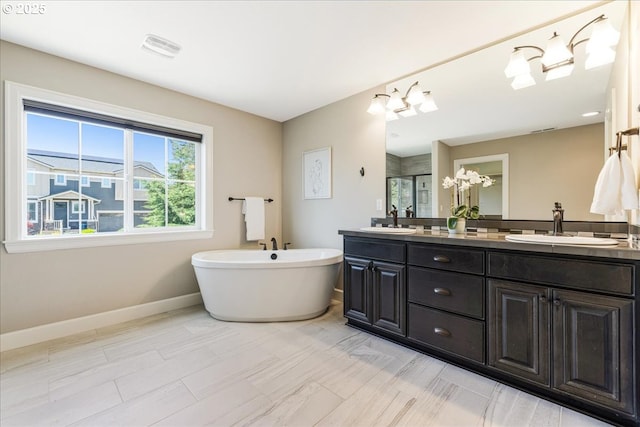 2025 De Vries Way W, Linn, OR 97068 - bathroom with double vanity, baseboards, a freestanding bath, and a stall shower