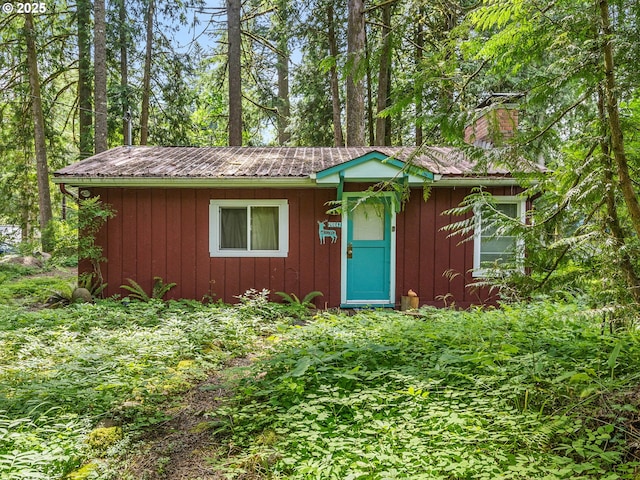 26647 E Welches Rd, Welches, OR 97067 - ranch-style house with a chimney, an outdoor structure, board and batten siding, and a metal roof