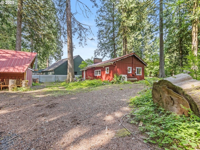 26647 E Welches Rd, Welches, OR 97067 - back of house featuring a chimney and board and batten siding