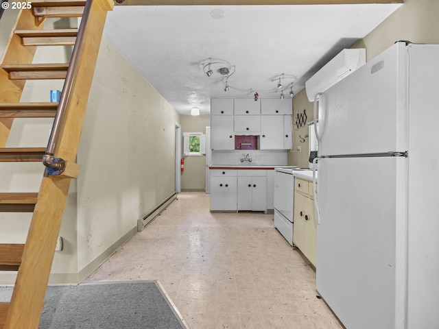 26647 E Welches Rd, Welches, OR 97067 - kitchen with white appliances, a baseboard radiator, white cabinetry, backsplash, and light floors