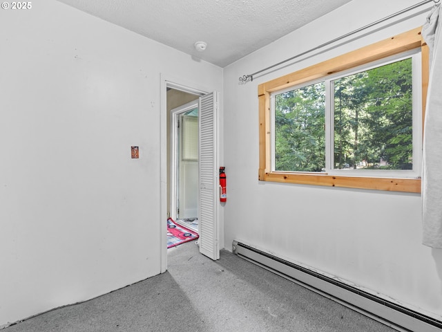 26647 E Welches Rd, Welches, OR 97067 - unfurnished room with baseboard heating, a smoke detector, and a textured ceiling
