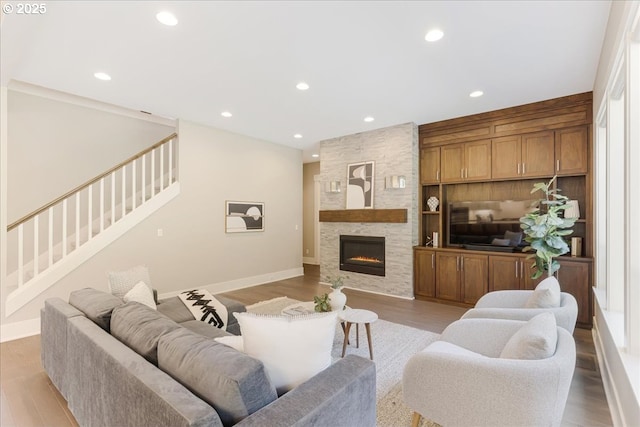 living room with stairs, recessed lighting, and baseboards
