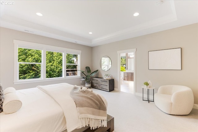 bedroom with recessed lighting, multiple windows, and a raised ceiling