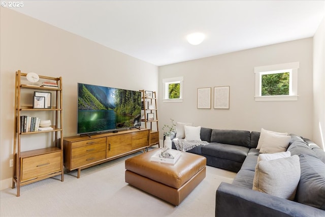 living area featuring light colored carpet and plenty of natural light