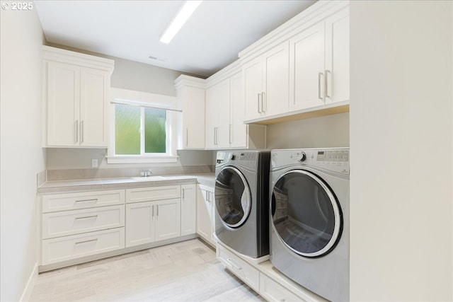 4726 SW 60th Pl, Portland, OR 97221 - clothes washing area with washing machine and clothes dryer and cabinet space
