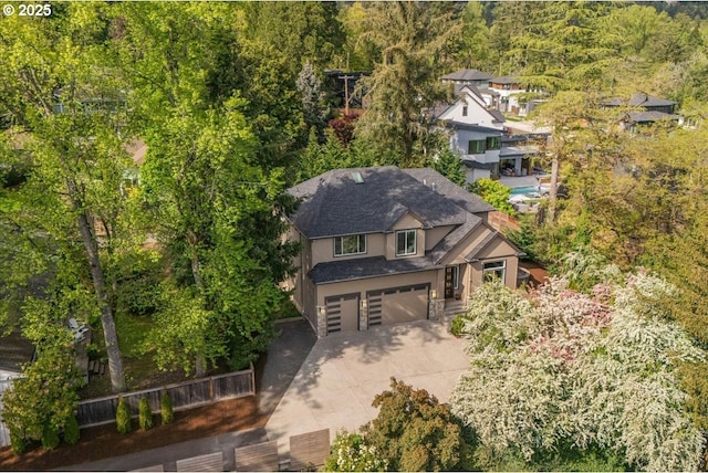 bird's eye view with a wooded view