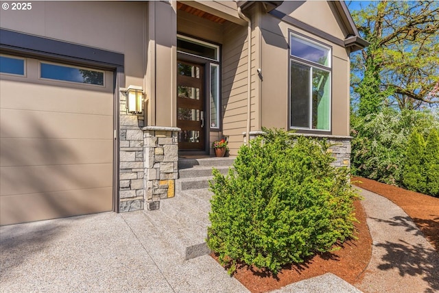 entrance to property with driveway and stone siding