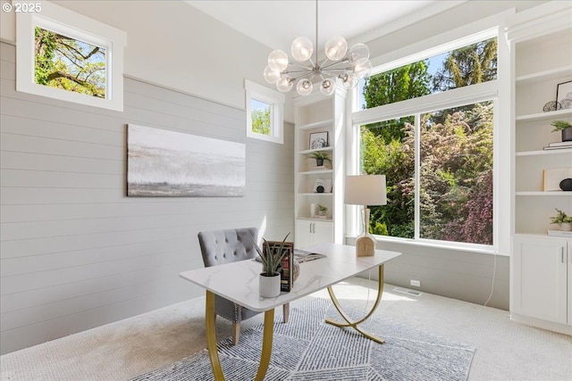4726 SW 60th Pl, Portland, OR 97221 - carpeted home office with wood walls, a chandelier, and built in shelves