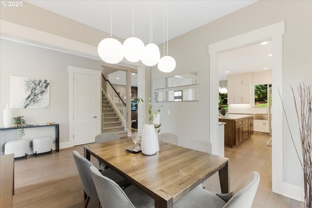 dining room with stairway, recessed lighting, and light wood finished floors