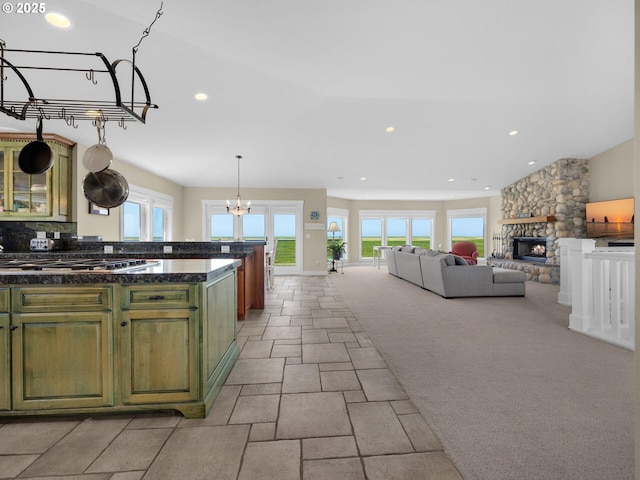 kitchen featuring green cabinets, stainless steel gas cooktop, plenty of natural light, dark countertops, and recessed lighting
