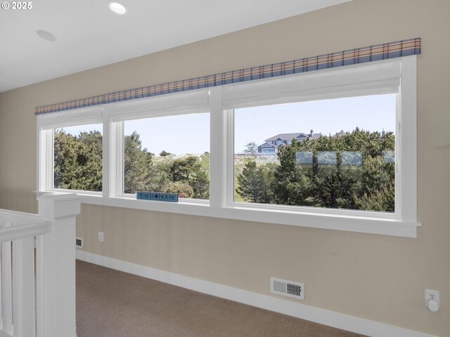 carpeted empty room featuring baseboards and recessed lighting