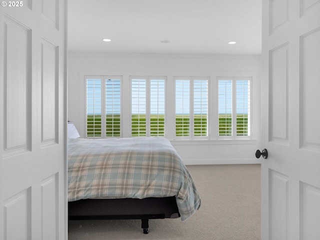 carpeted bedroom featuring ornamental molding and recessed lighting