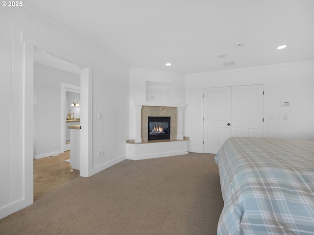 bedroom featuring carpet floors, crown molding, a fireplace, baseboards, and recessed lighting